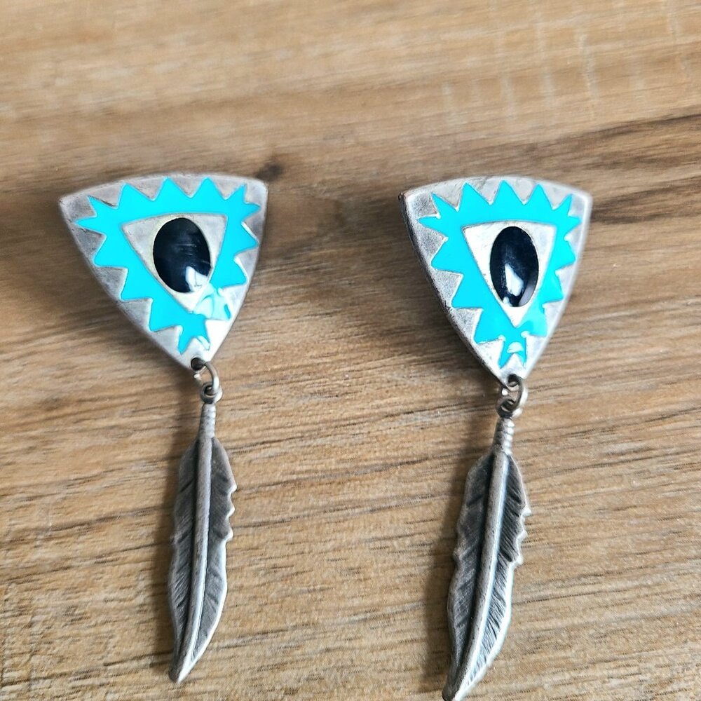 Western style silver color metal dangling earrings.